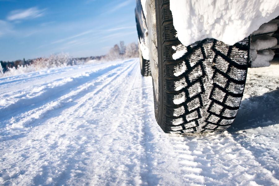 Car with winter tires on snowy road
