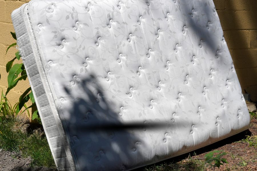 Discarded mattress leaning against the wall