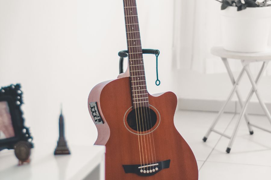 Acoustic guitar on stand in room
