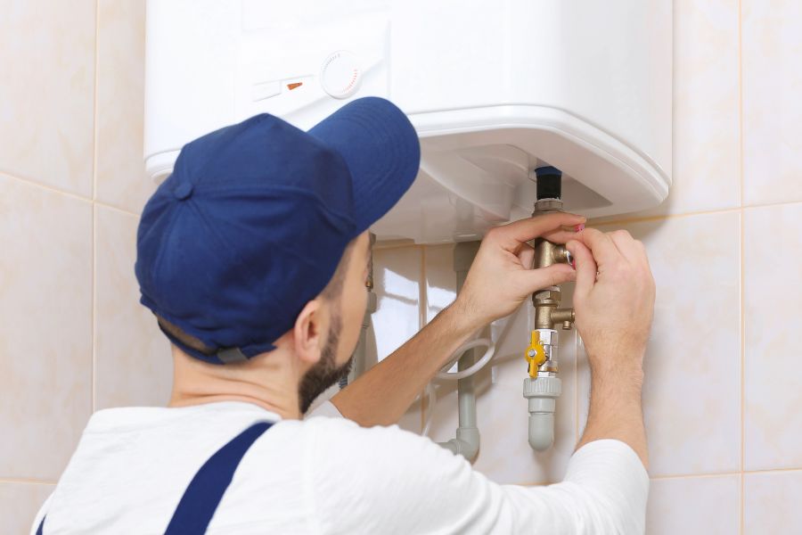 Plumber installing tankless water heater