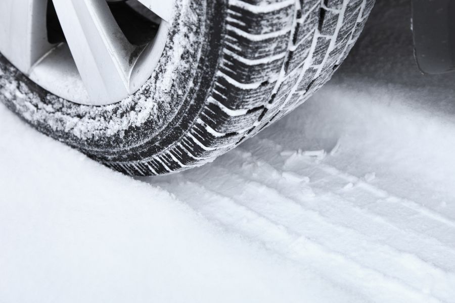 Winter tire on the road covered with snow