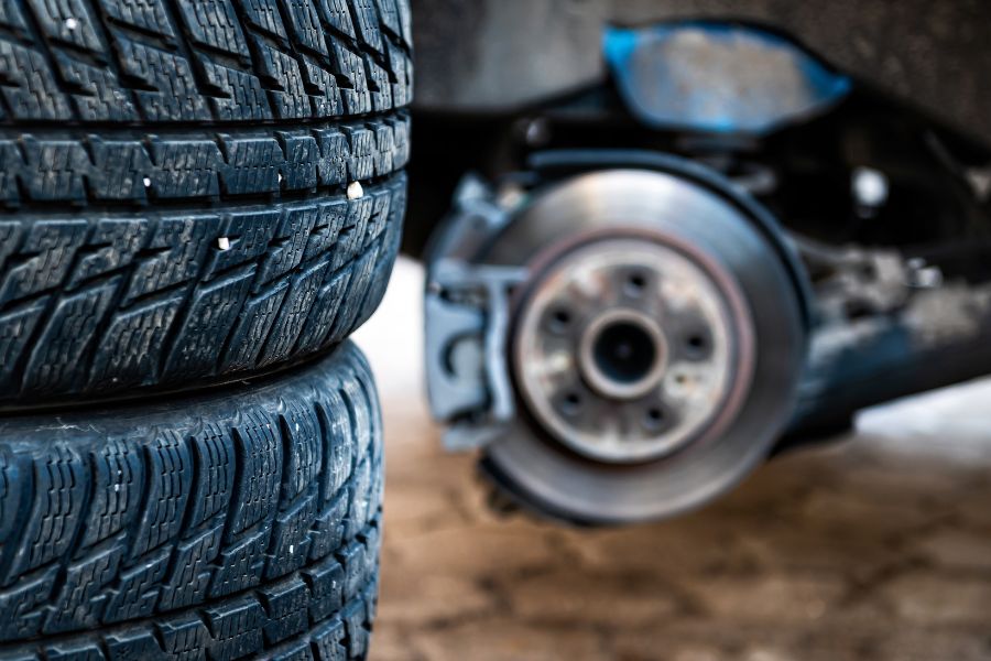 Car tires change with winter tires next to the car