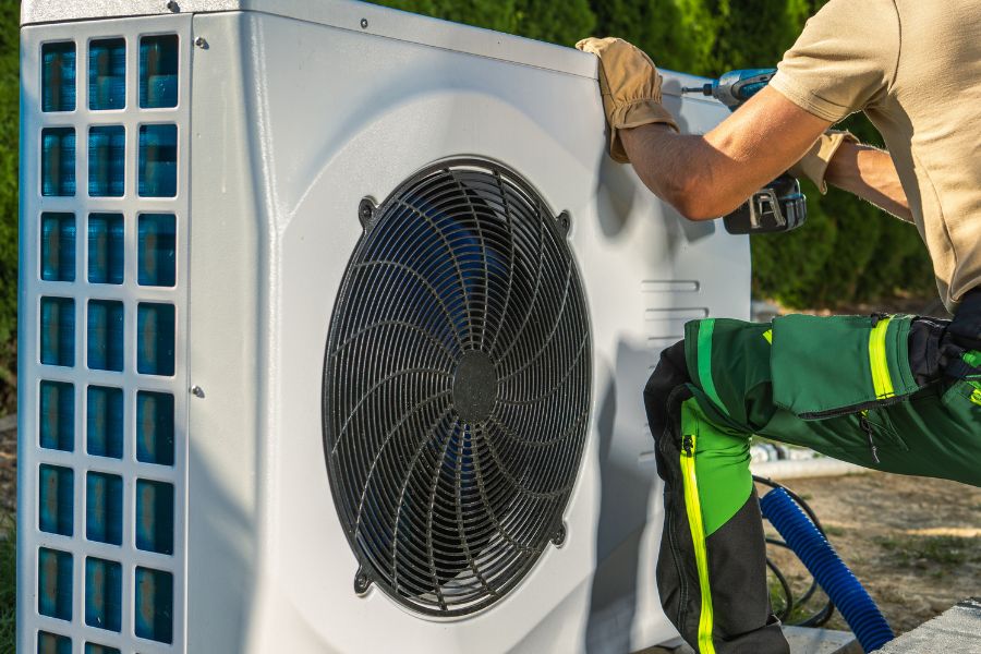 HVAC worker installing heat pump