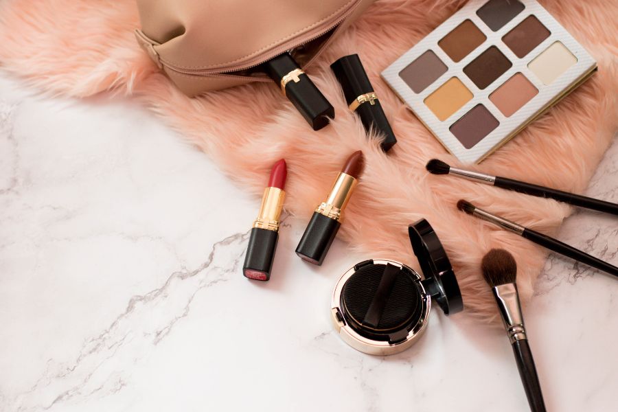 Makeup kit with beauty products on fur carpet