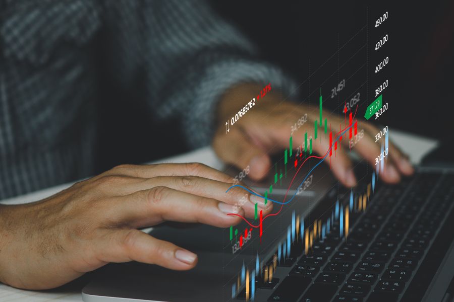 Businessman analysing stock market candlestick and graphs