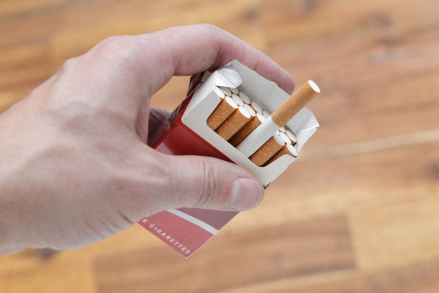 Man holding pack of cigarettes