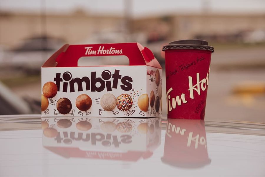 Timbits donut box and cup of coffee by Tim Hortons