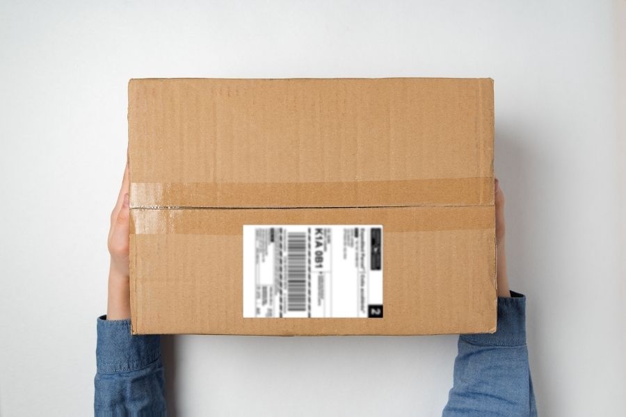 Hands holding a Canada Post shipping package